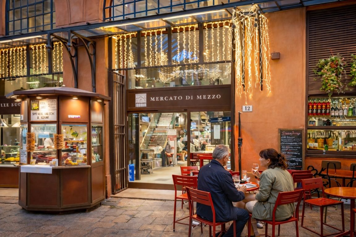 Historic Mercato di Mezzo food market in Bologna illuminated at night, photographed during a Bologna Italy Food Tours culinary tour.